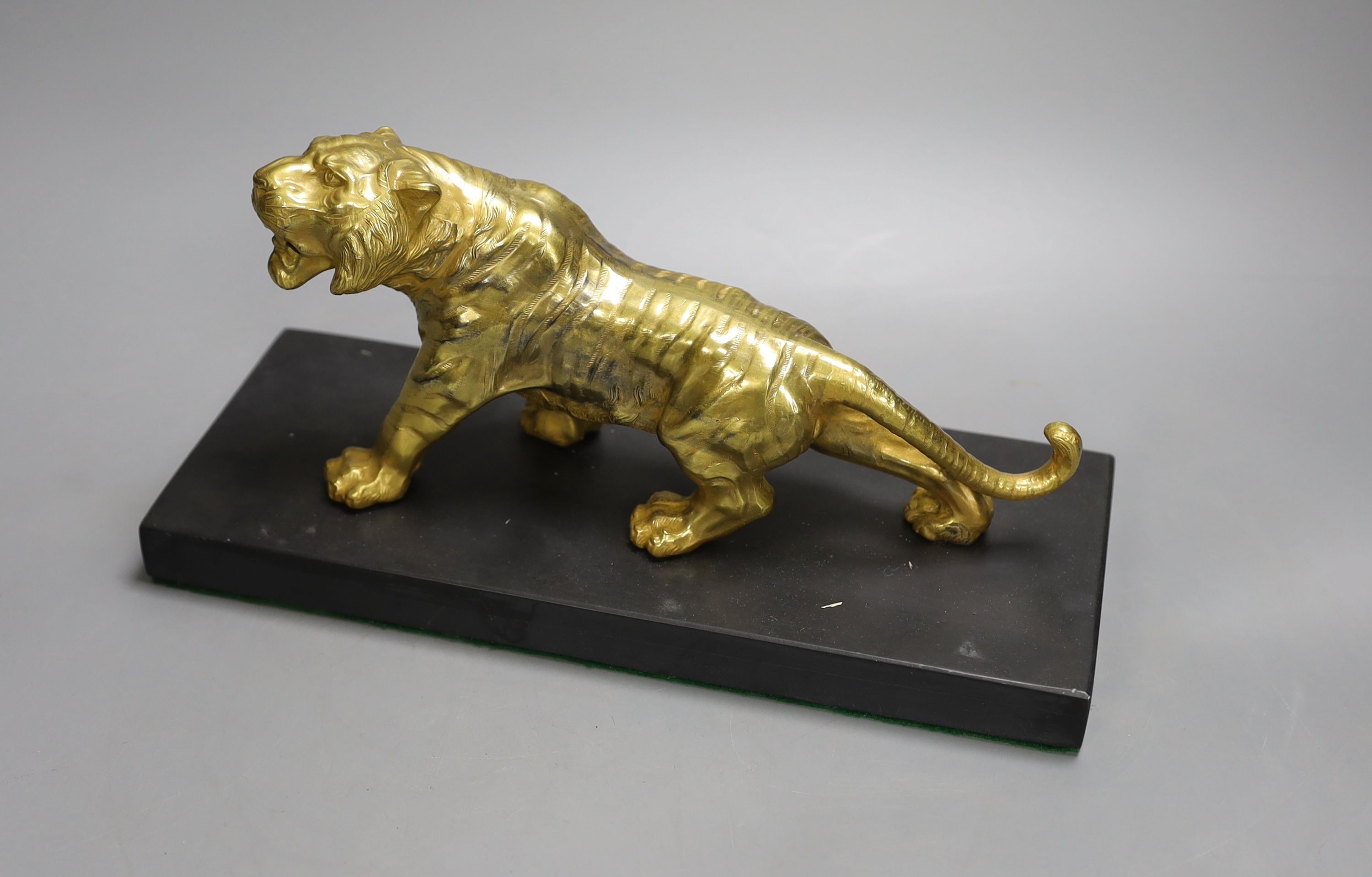 A gilt bronze figure of a tiger on base - 13cm tall